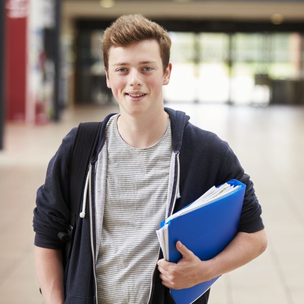 Portrait Of Male Student Standing In College Building